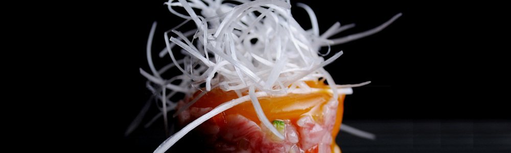 Close detail of Kobe beef plating with fresh herbs