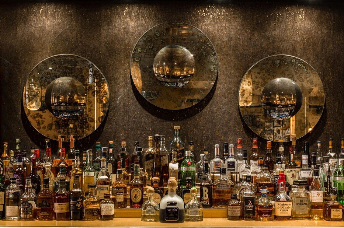 Bar shelving stocked with whiskey and wine bottles